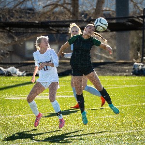 Female soccer player heading the ball